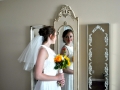 Bride in front of stating room mirrors
